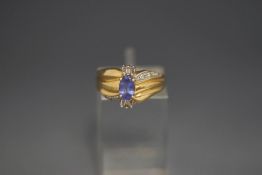 A tanzanite and diamond ring, stamped '14K', finger size L, 3.
