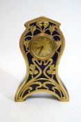 An Art Nouveau style blue glazed earthenware clock, with decorative pierced brass mount,