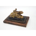 A Chinese soapstone carving of a recumbent water buffalo and it's calf, with a boy upon it's back,