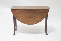 A George III mahogany oval drop leaf pad foot dining table, 72cm high x 101.
