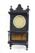 A Victorian ebonised hanging wall shelf, with inset circular mirror,
