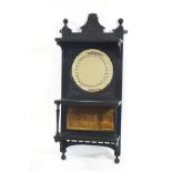 A Victorian ebonised hanging wall shelf, with inset circular mirror,