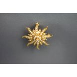 A sun in splendour seed pearl set pendant brooch, stamped '14K', 3.