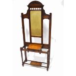 An Edwardian mahogany hall stand with eight hooks, flanking a mirror above one drawer,