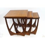 A nest of three Ercol style teak tables,