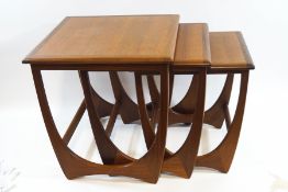 A nest of three Ercol style teak tables,