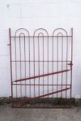 An iron gate, painted red, 152cm high x 118cm wide,