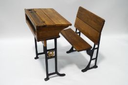 An early 20th century oak school desk with iron base, from Christ's Hospital,