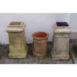 A pair of reconstituted stone chimney pots, with square tops, 67cm high,