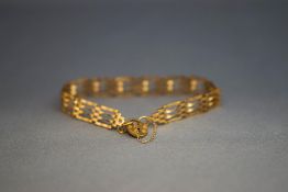 A 9 carat gold bracelet, of four bar gate links, 4.