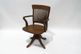 A 20th century oak office swivel chair