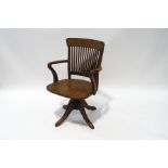 A 20th century oak office swivel chair