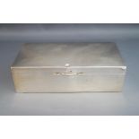 A silver cigarette box, of plain rectangular form, wooden lined,