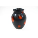 A Poole Pottery 'Living Glaze' baluster vase, raised orange red spots over a matte black ground,