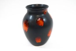 A Poole Pottery 'Living Glaze' baluster vase, raised orange red spots over a matte black ground,