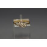 A three stone illusion set diamond ring, stamped '18ct & Plat', 2.