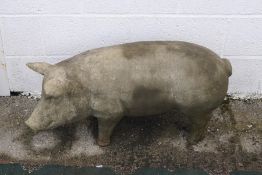 A reconsitituted stone garden pig ornament,