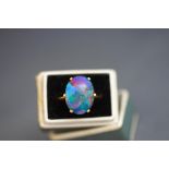 An opal triplet ring, unmarked, finger size K, 5 g gross,