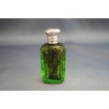 A Victorian green cut glass scent bottle, with silver coloured embossed hinged cover,