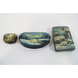 Three Russian lacquered boxes, the larger two their lids painted with snowscapes, 17.5cm and 15.