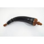 A cow horn black powder flask, with turned wood end and stopper,