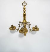 A brass three branch wall sconce with drip pans,