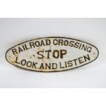 A cast iron oval railroad crossing sign,
