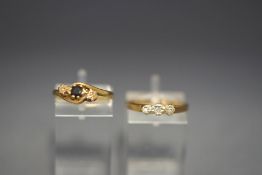 A 9 carat gold sapphire and illusion set three stone diamond ring;