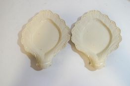A pair of 18th century English Creamware dishes, both moulded with shell shaped handles,