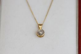 A single stone diamond pendant, stamped '9k', the brilliant cut illusion set, on a chain, 1 g gross,