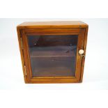 A small pine cabinet with glazed front,