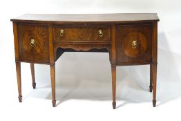 A Regency style mahogany bow fronted sideboard, the central drawer flanked by two cupboards,