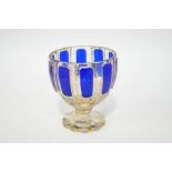 A Bohemian glass goblet, with panels of blue overlay and profuse gilt patterning,