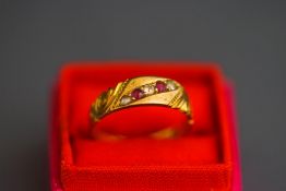 An 18ct gold ruby and rose cut diamond ring, the alternate set line to a carved head mount,