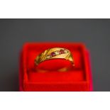 An 18ct gold ruby and rose cut diamond ring, the alternate set line to a carved head mount,