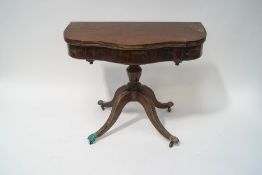 A 19th century mahogany tea table with serpentine shaped top on turned pedestal with four splayed