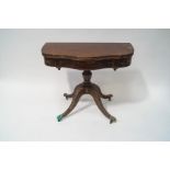 A 19th century mahogany tea table with serpentine shaped top on turned pedestal with four splayed