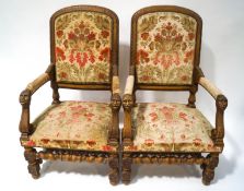A pair of 19th century continental elbow chairs, each with carved mahogany frames,