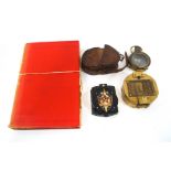 A WWI military compass, leather cased, a brass compass, a Russian compass with enamel badge to lid,