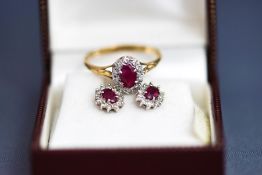 A 9 carat gold ruby and diamond cluster ring, finger size R1/2; and a similar pair of earstuds,