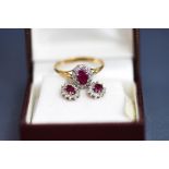 A 9 carat gold ruby and diamond cluster ring, finger size R1/2; and a similar pair of earstuds,