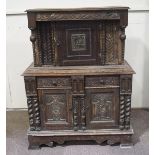 A 17th century style oak court cupboard incorporating 17th century elements with one cupboard door