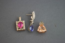 A single tanzanite and diamond 9 carat white gold drop earring; with two stone set pendants; 4.