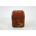 A Japanese red lacquered box and cover, with gilded decoration of cranes and flowering branches,