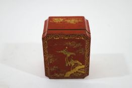 A Japanese red lacquered box and cover, with gilded decoration of cranes and flowering branches,