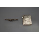 A late Victorian silver vesta case; and a fox stock pin,