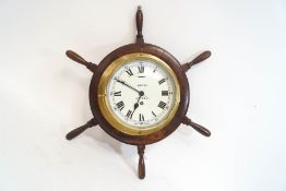 A Smiths Astral baulkhead clock, mounted onto a ships' wheel,