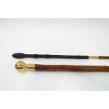 Two simple walking canes, one with brass ball finial,
