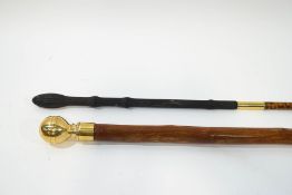Two simple walking canes, one with brass ball finial,
