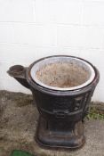 A cast iron log boiler converted into a planter,